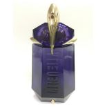 A large bottle of Alien perfume (empty).