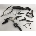 A box of gun mechanisms, Spurs and other parts.