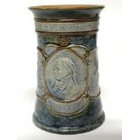 A Royal Doulton stone ware vase dipicting Lord Nelson with the inscription Every Man will do his