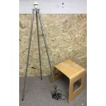 A floorstanding, folding metal tripod stand and a