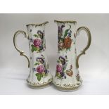 A pair of Dresden jugs decorated with flowers an f