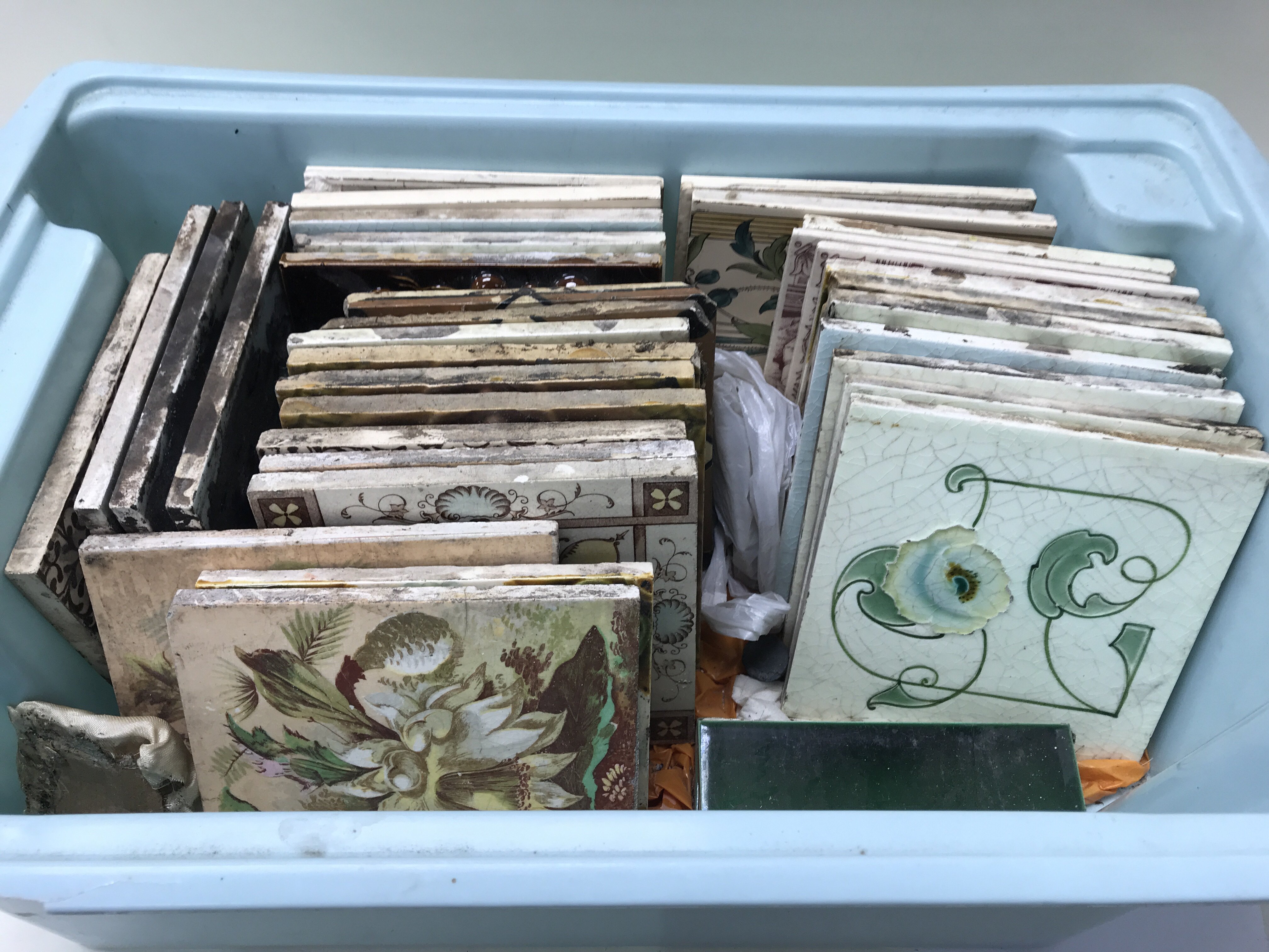 A box of art nouveau and Victorian tiles.