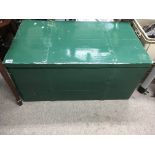 A painted green pine trunk with metal bound top. A