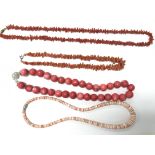 A collection of 4 necklaces including 3 coral.