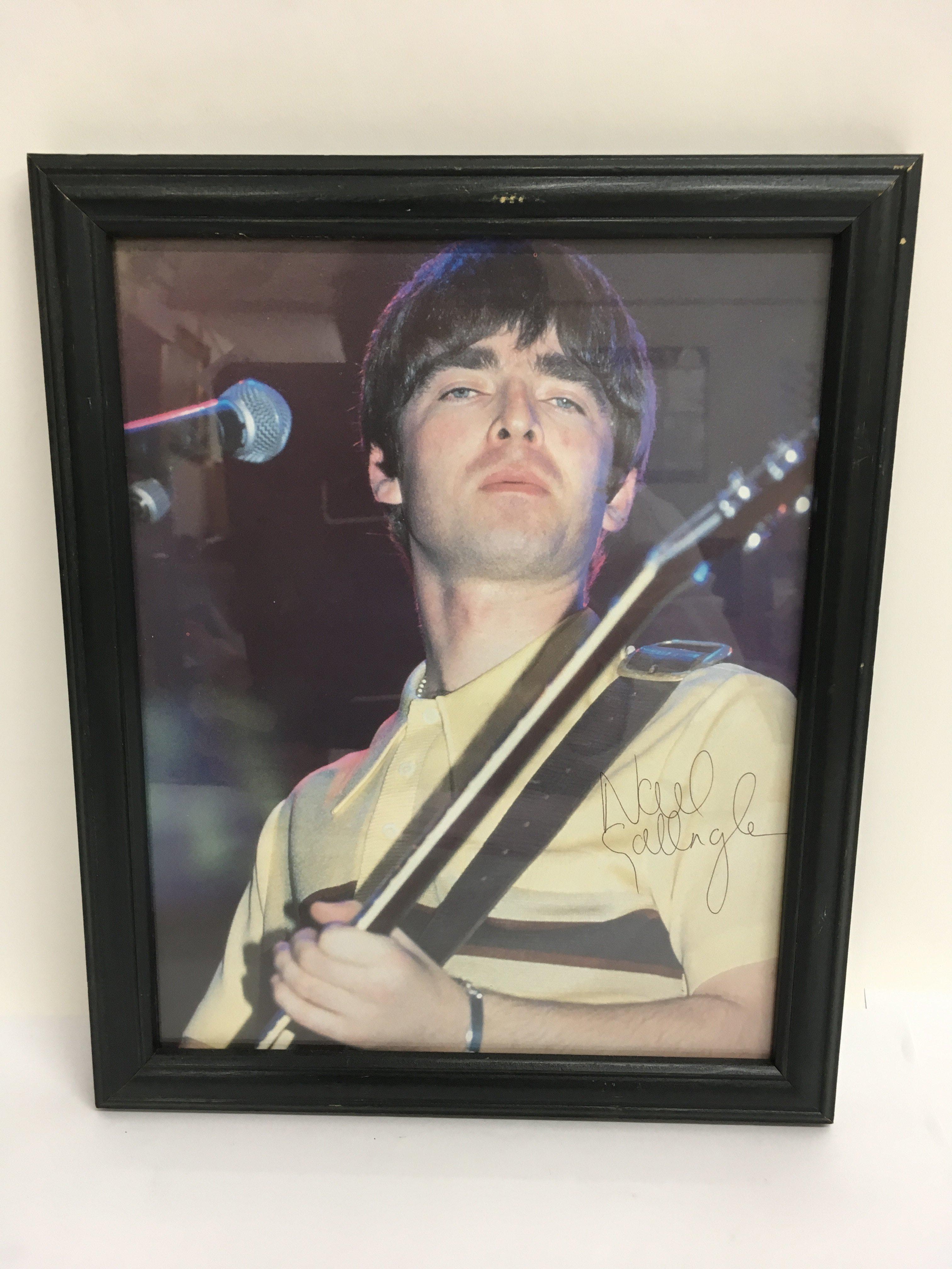 A framed and glazed signed photo of Noel Gallagher