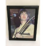 A framed and glazed signed photo of Noel Gallagher