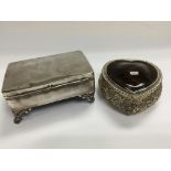 A silver and tortershell heart shaped trinket box