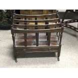 A mahogany Canterbury open magazine rack fitted wi