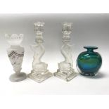 A small collection of glassware including candle s