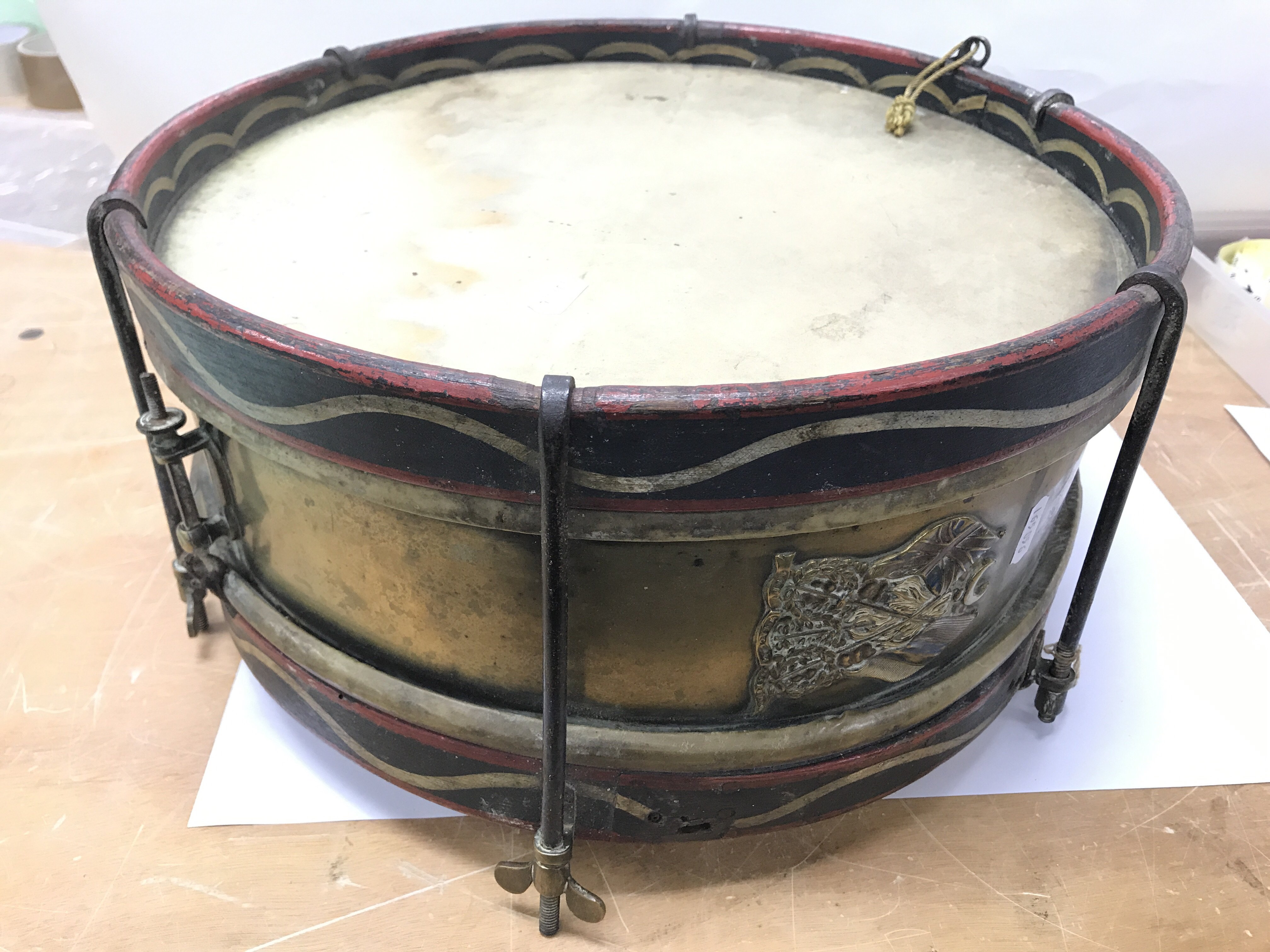A military snare drum with a badge to the side of