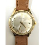 A gents 9ct gold Garrard automatic wristwatch. Thi