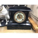 A Victorian black mantel clock the dial with Roman numerals