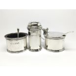 A cased silver and blue glass condiment set comprising of a petite pepper shaker, a mustard pot