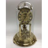 An anniversary clock under a glass dome, approx 29cm.