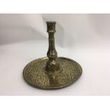 A Indo- Persian brass candlestick with detailed engraved decoration. 20 cm