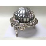 A silver plated, revolving top, butter/caviar dish.