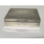 A Silver cigarette box of rectangular shape engraved with initials and date. Cedar lined. Birmingham