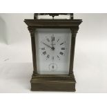 A French brass carriage clock with alarm push button repeat ,visible platform escapement , the