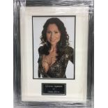 A framed and glazed photograph of Minnie Driver with attributed signature, approx 33.5cm x 45cm.