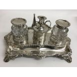 A fine quality Victorian silver inkwell stand of shaped form with two pierced holders containing