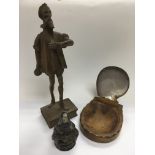A carved wooden figure, Continental metal inkwell and a folding dish with clam shell top (3).