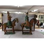 A pair of reproduction Japanese figures riding horses. A/F