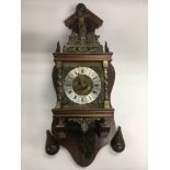 A Dutch mahogany and brass wall clock with brass motifs.