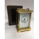 A brass carriage clock with leather outer travelling case.