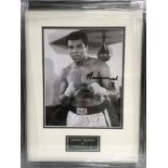 A framed and glazed photograph of Muhammad Ali with attributed signature, approx 35.5cm x 45.5cm.