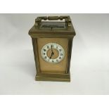 A French brass carriage clock with repeat button visible escapement the dial with Roman Arabic