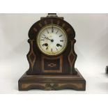 A mahogany inland mantle clock the circular dial with Roman numerals