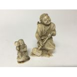 Two carved 19th Century Japanese ivory carvings of a figure holding a large mallet and a smaller