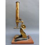 A cased late 19thC / early 20thC brass microscope