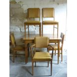 A retro Gordon Russell light oak extending dining table and five leatherette upholstered chairs,