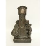 A late 19thC bronze clock in the form of a longcase clock with two of Dutch children,