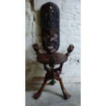 A carved African mask and figural table,