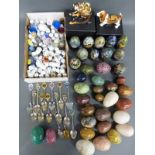 A collection of various agate, turned mineral and cloisonné eggs, thimbles,