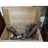 A large wooden chest containing a large collection of wooden vintage planes, bows,