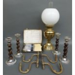 An oil lamp with glass shade together with four candle sticks of barley twist design,