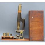 A Smith & Beck, London brass microscope in mahogany case with various lenses,