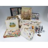 A box of loose stamps, a Trusty stamp album,