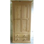 A pair of pine single wardrobes with two drawers under,