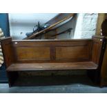 A small pine pew with panelled back,
