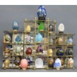 A quantity of decorative eggs including glass, cloisonné,