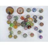 Thirty-nine handmade glass marbles including multi-coloured latticino examples,