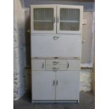 A retro 1950s kitchen cabinet with fold down surface and fitted interior,