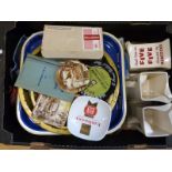 Two trays of breweriana including vintage beer mats, tea towels including Babycham,