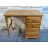 A small pine desk with four drawers,