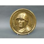 A brass plaque depicting Mussolini flanked by the letters DVX and AX III,