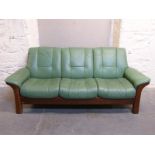 A Stressless three seater green leather sofa
